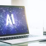 Un ordinateur portatif ouvert dont l'écran affiche le logo AI